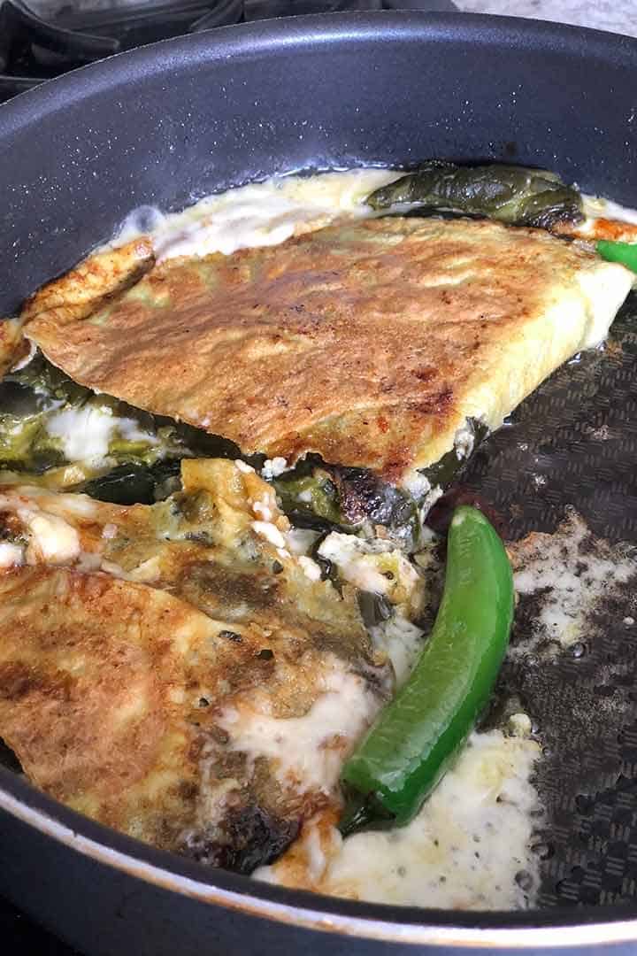 Pan frying until chiles rellenos foldie recipe is golden crispy.